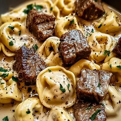 Cracked Garlic Steak Tortellini Irresistible Creamy Dinner 3 Creamy garlic steak tortellini with seared beef and parmesan sauce in bowl
