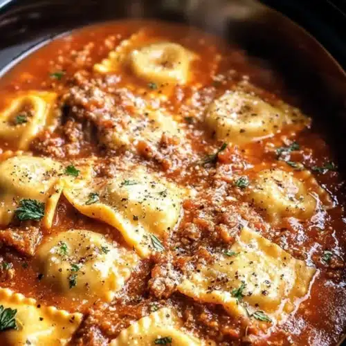 Crockpot ravioli lasagna with cheese-filled pasta in rich tomato sauce