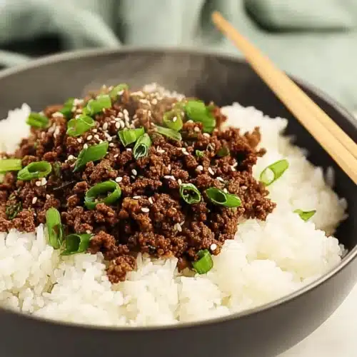Korean ground beef bowl with rice, sesame seeds, and green onions
