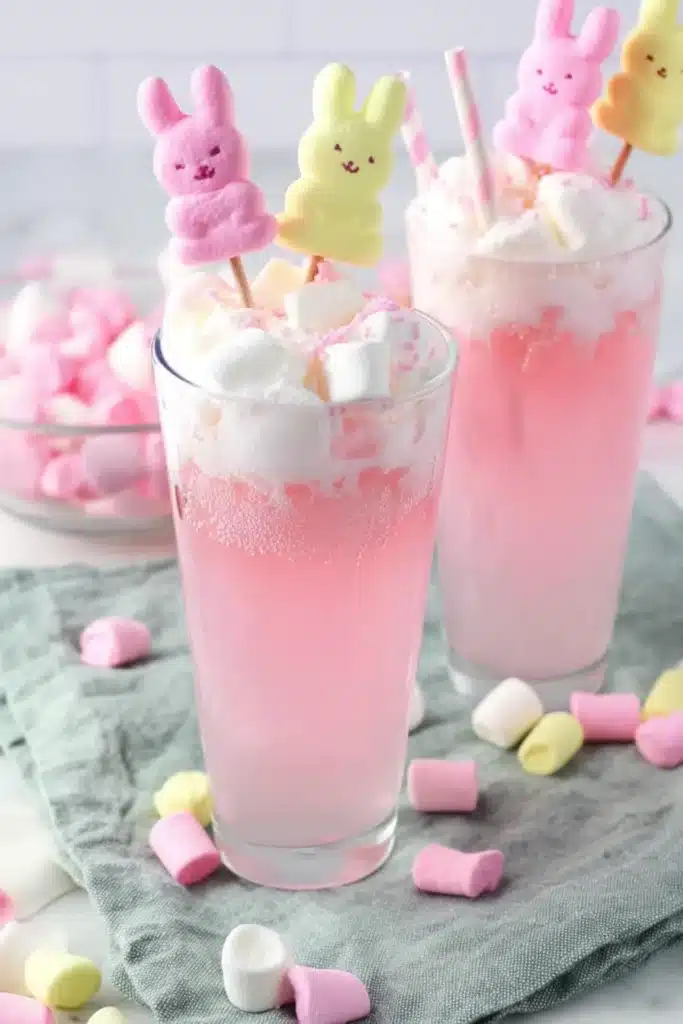 Easter Bunny Punch Recipe That’s Sweet, Fizzy, and Fun 1 Layered pink Easter Bunny Punch with marshmallows and bunny candy topper