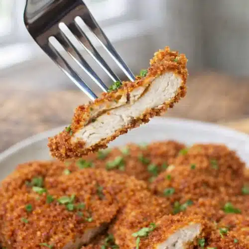 Fried Chicken Cutlets 4 Crispy fried chicken cutlet sliced on fork with juicy center
