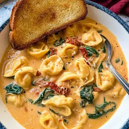 Creamy Marry Me Chicken Soup with spinach, pasta, and toasted bread in rustic bowl