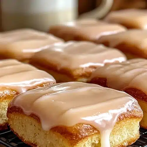 Soft Baked Maple Donut Bars topped with a smooth, glossy maple glaze. Golden edges and fluffy texture make this cozy breakfast treat irresistible and bakery-worthy.
