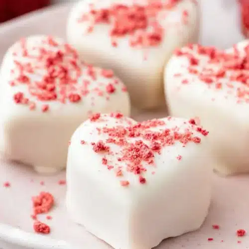 Strawberries and Cream Truffle Hearts and cream truffles coated in white chocolate and topped with red strawberry crumbs