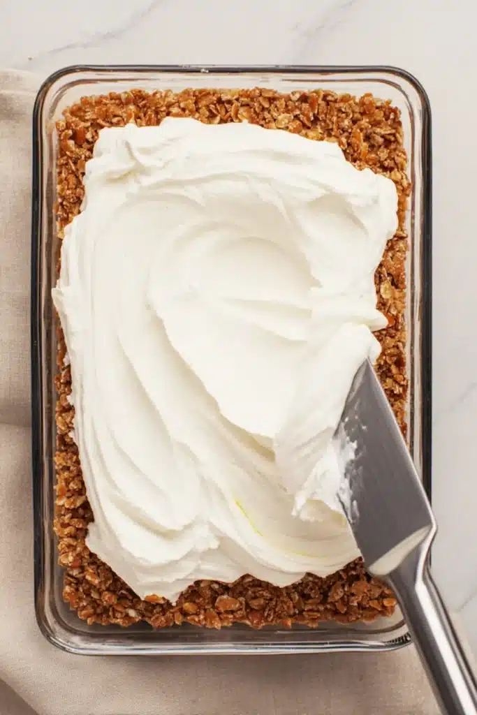 Strawberry Pretzel cream cheese layer spread over crunchy pretzel crust