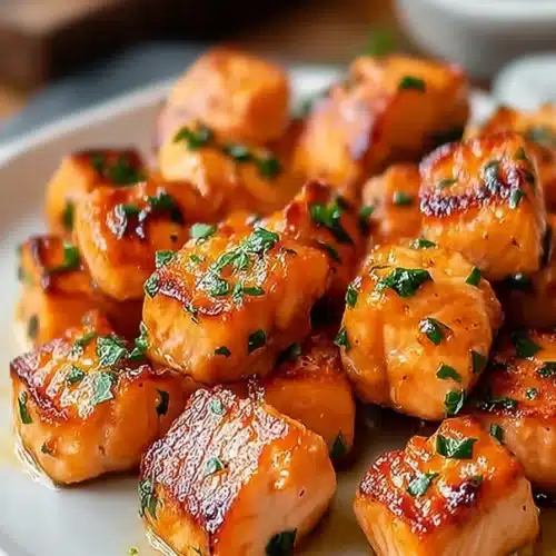 Air Fryer Honey Garlic Salmon 4 Air fryer honey garlic salmon bites with crispy caramelized glaze and fresh herbs on a plate