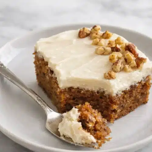 Carrot Cake With Cream Cheese Frosting slice on plate with fork
