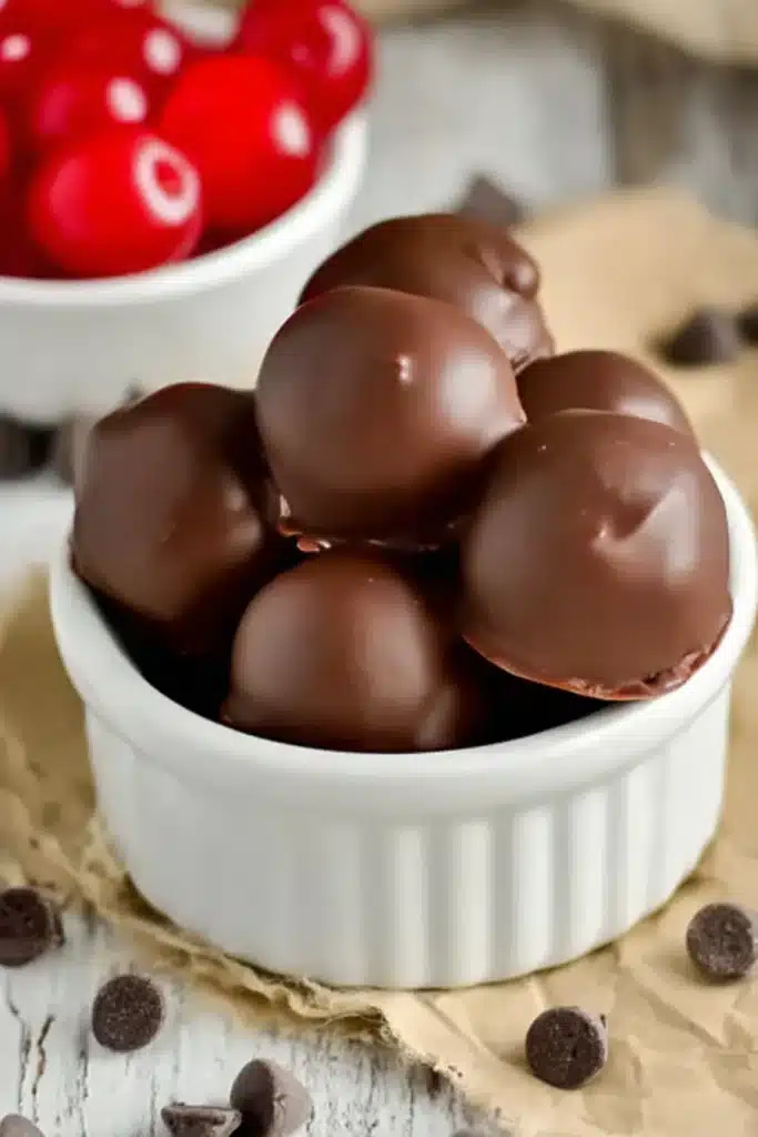 Cherry Brownie Bombs in a ramekin with chocolate coating and cherries