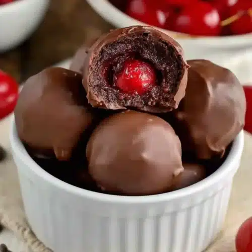 Cherry Brownie Bombs with chocolate coating and cherry center in ramekin