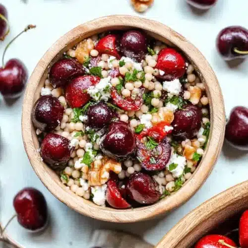 Cherry walnut couscous salad with feta and walnuts in ceramic bowl