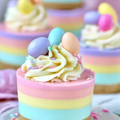 Easter No-Bake Mini Cheesecakes with pastel layers and whipped cream