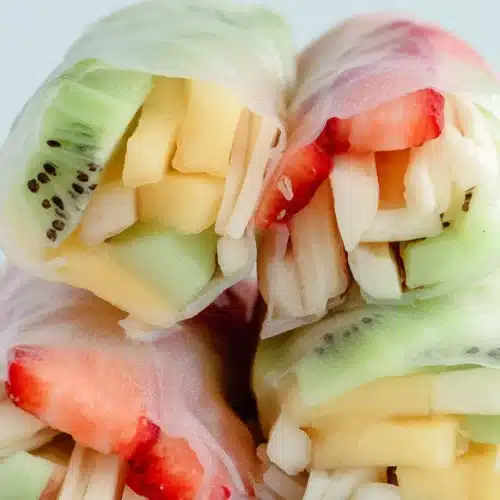 Fresh fruit spring rolls with colorful sliced fruit wrapped in soft rice paper