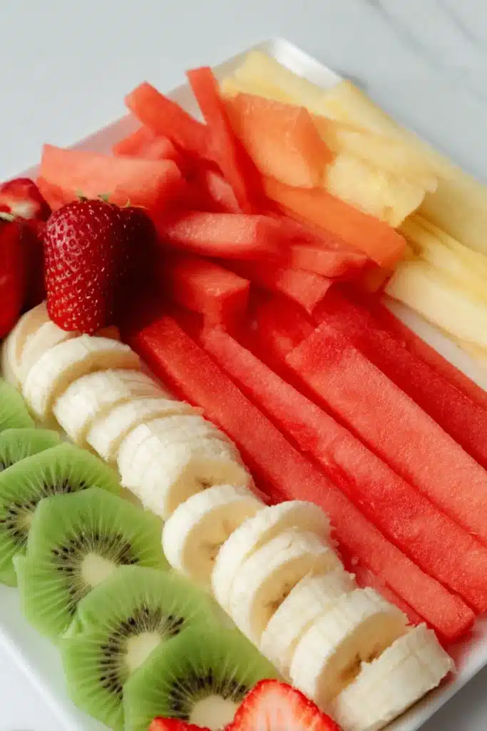 Fresh sliced fruits for fruit spring rolls including kiwi, strawberry, pineapple and watermelon