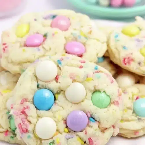 Funfetti Cake Cookies 4 Soft funfetti cake cookies with pastel M and M candies and white chocolate chips on mint plate