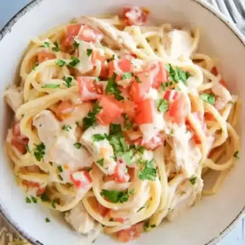 Instant Pot Chicken Spaghetti 3 Creamy instant pot chicken spaghetti with tomatoes and parsley in white bowl
