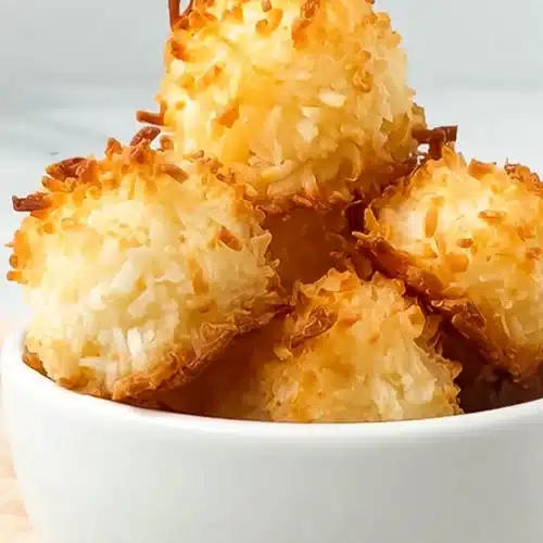 Keto coconut macaroons with crispy golden edges in a white bowl