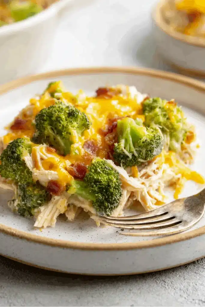 Low Carb Chicken Casserole with broccoli, bacon, and melted cheddar on plate