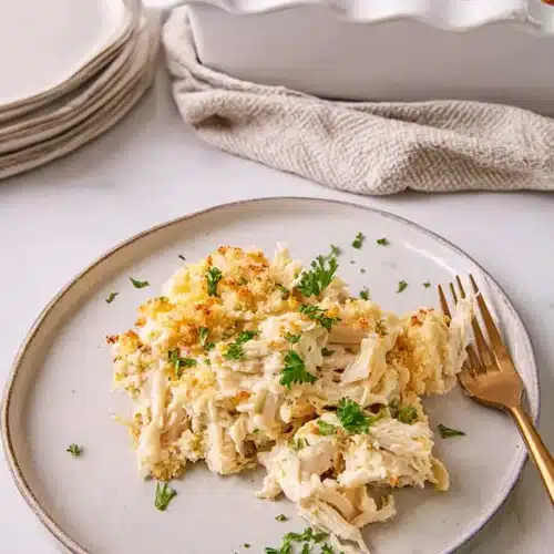 Plated Million Dollar Chicken Casserole with creamy chicken and golden topping