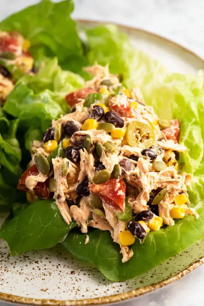 Southwest Chicken Salad 1 Southwest Chicken Salad served in lettuce cups with beans and corn