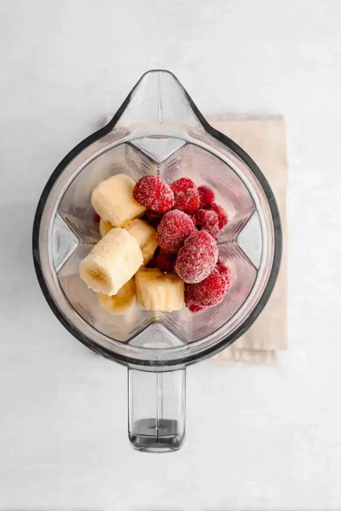 Strawberry Banana Smoothie Bowl ingredients frozen fruit in blender