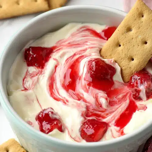 Strawberry Cheesecake Dip 3 Strawberry cheesecake dip with graham crackers and glossy fruit swirl
