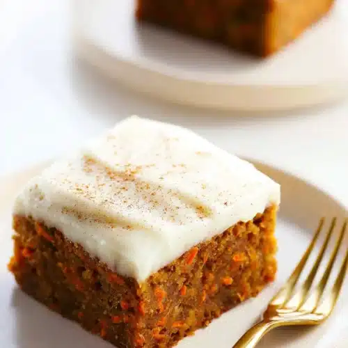 The Best Carrot Cake Bars for a Sweet Easter Treat 3 The best Carrot Cake Bars with cream cheese frosting on ceramic plate