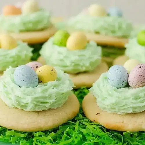 Easter sugar cookies with green buttercream nests and pastel candy eggs