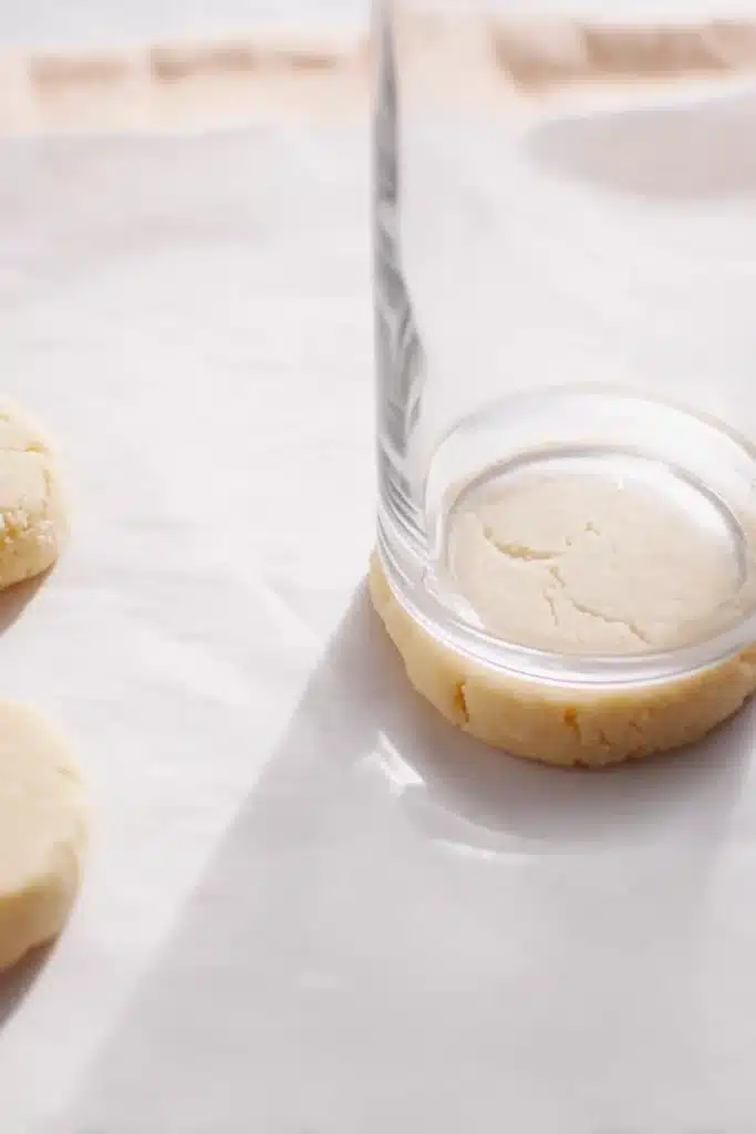 The best easter Sugar Cookies dough flattened with glass on parchment paper