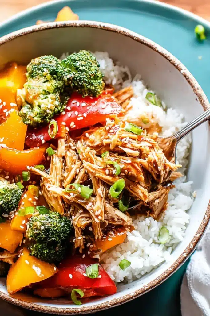 Crock pot teriyaki chicken cooking in slow cooker with chicken breasts in teriyaki sauce