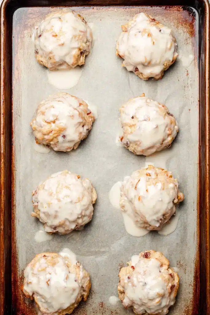 Baked Rhubarb Fritters Recipe You’ll Love 2 Baked Rhubarb Fritters with glaze on baking sheet