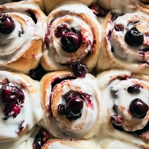 Cherry cinnamon rolls with cream cheese frosting and glossy cherry filling