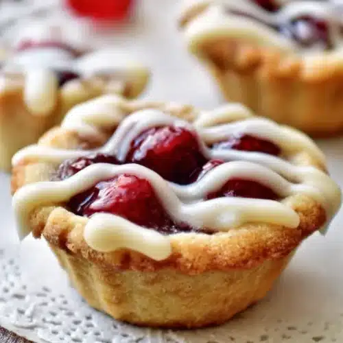 Cherry pie cookie cups with glaze on a rustic plate