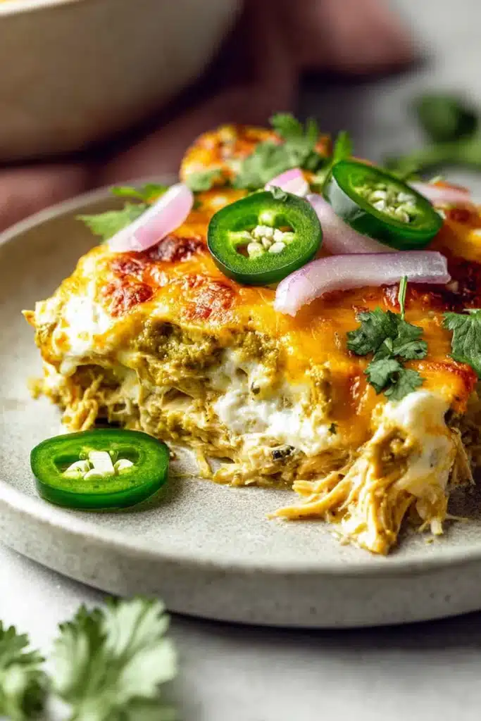 Delicious Salsa Verde Chicken Casserole 1 salsa verde chicken casserole slice with melted cheese and jalapeños