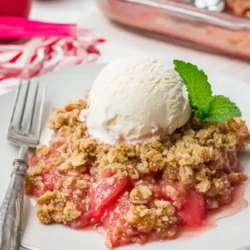 Easy rhubarb crisp with oat topping and vanilla ice cream on a plate