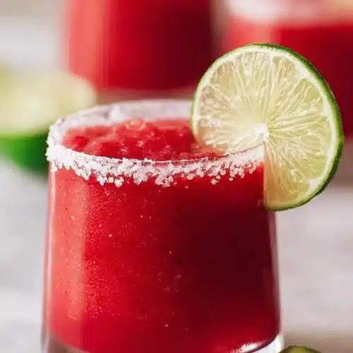 Frozen Strawberry Margarita with salted rim and lime slices