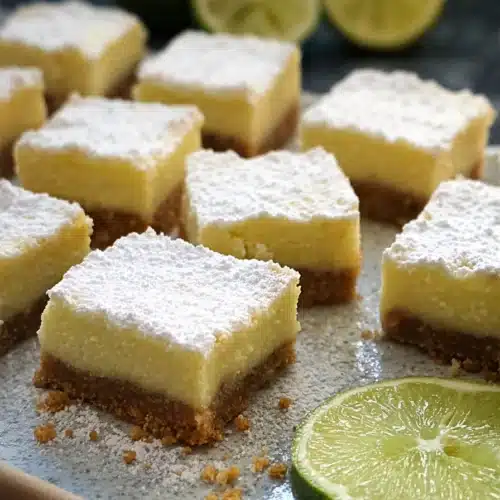 Lime margarita bars with creamy filling and graham crust dusted with powdered sugar