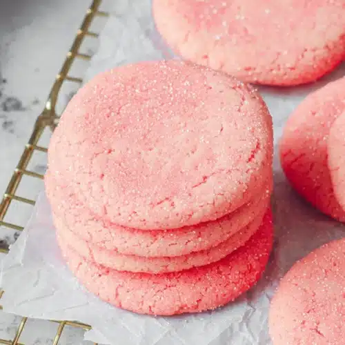 Mexican Pink Cookies Recipe That’s Soft, Buttery, and Easy 4 Mexican pink cookies with sugar topping on parchment paper cooling rack