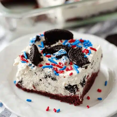 No Bake Fireworks Oreo Cheesecake Bars slice with sprinkles on plate