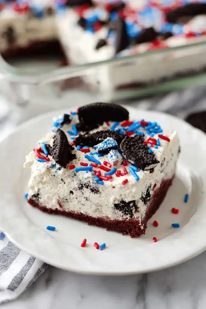No Bake Fireworks Oreo Cheesecake Bars slice with sprinkles on plate
