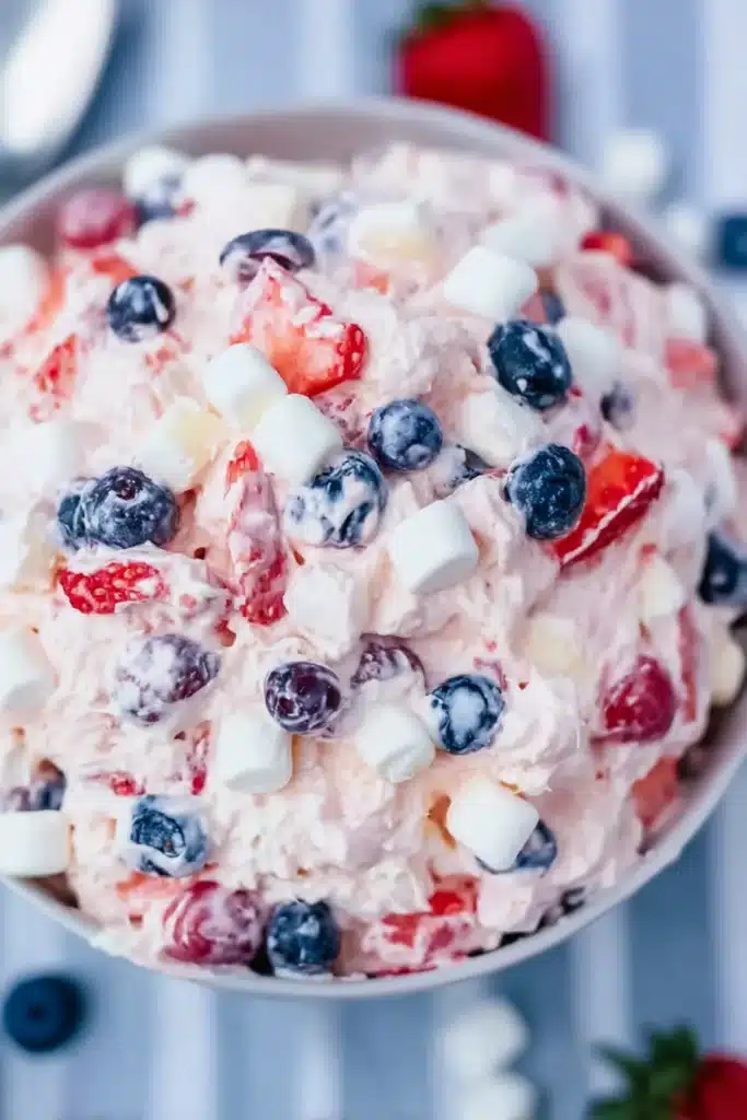 Red White and Blue Cheesecake Salad 3 Red White and Blue Cheesecake Salad close up with strawberries blueberries and marshmallows