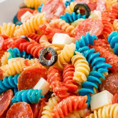 Red white and blue pasta salad with pepperoni, mozzarella, and olives