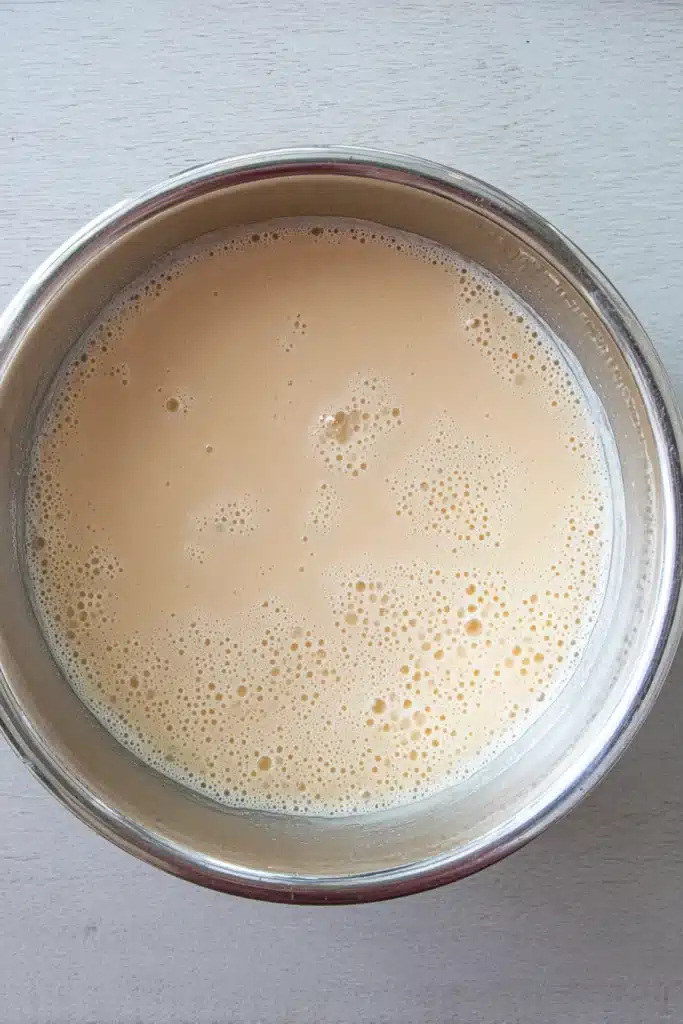 Rhubarb ice cream custard base mixture in bowl with smooth creamy texture