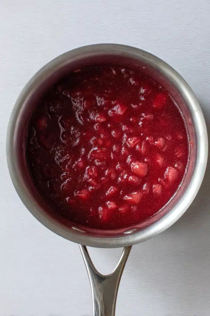 Rhubarb ice cream jam mixture cooking in saucepan with glossy texture