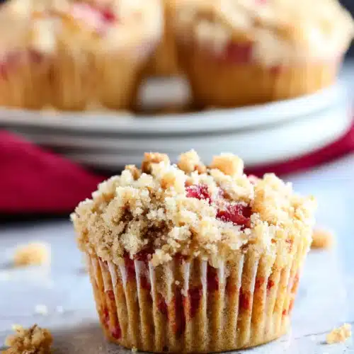 Rhubarb muffins with streusel topping on marble surface close-up