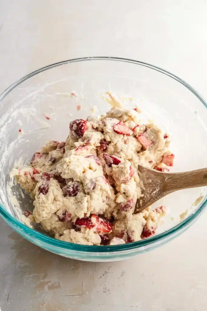 Strawberry Rhubarb Scones dough mixed in glass bowl with fresh fruit