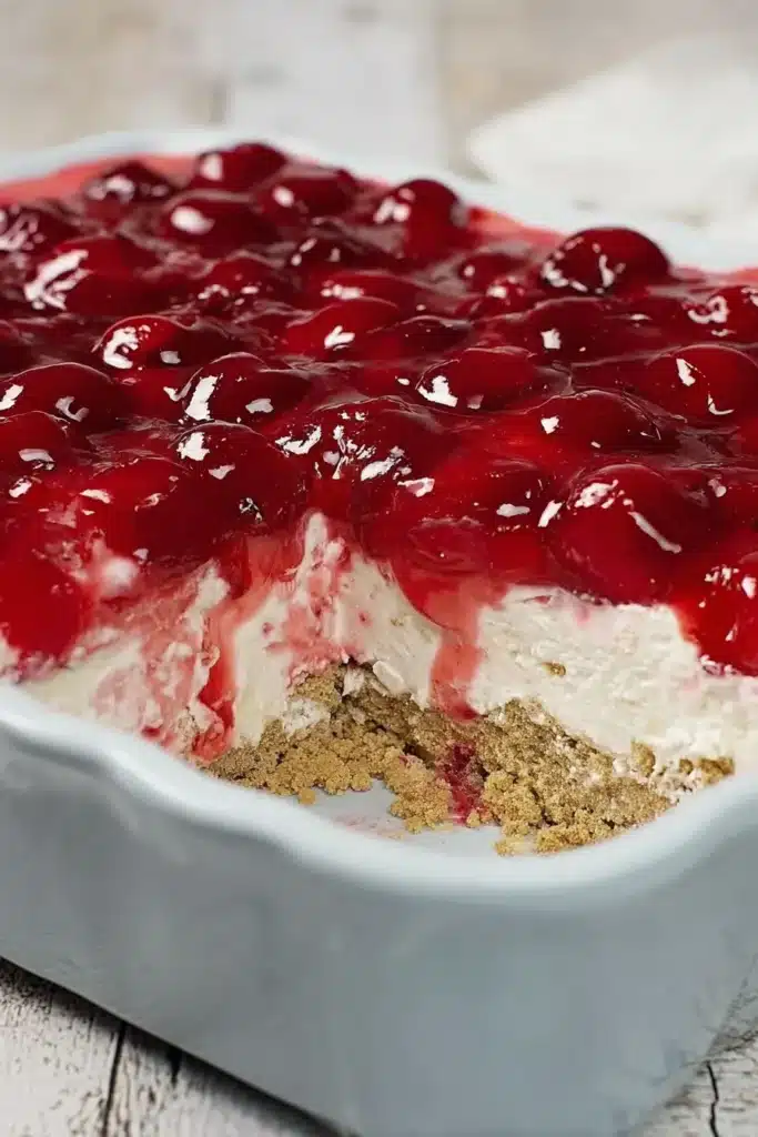Classic Cherry Delight in baking dish showing creamy layers and cherry topping