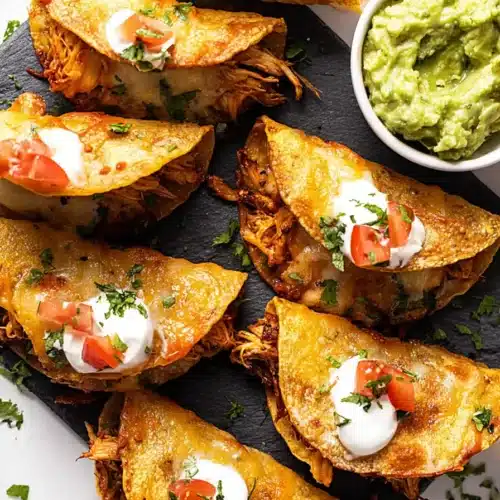 Mini Baked Chicken Tacos crispy and cheesy on baking tray