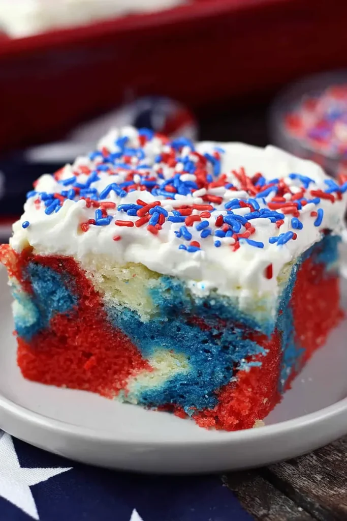 Close up of Patriotic Poke Cake showing red white blue texture and sprinkles