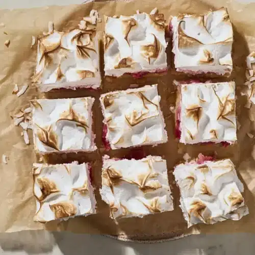 Rhubarb Meringue Dessert bars with fluffy toasted topping and creamy fruit layers