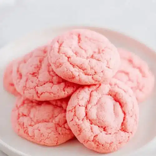 Strawberry Cake Mix Cookies stacked on a plate with soft chewy texture